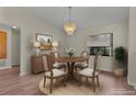 Cozy dining area with a wood table, chandelier, and a large window at 35534 Quail Run, Leesburg, FL 34788