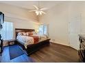 Main bedroom with king bed, dark wood furniture, and dark flooring at 3817 Doune Way, Clermont, FL 34711