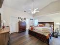 Spacious main bedroom with dark wood furniture and a ceiling fan at 3817 Doune Way, Clermont, FL 34711