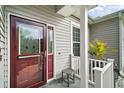 Dark-red front door with glass inserts and sidelights at 3839 Manor Oaks Ct, Leesburg, FL 34748