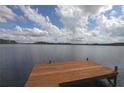 Lakefront property with a large wooden dock at 9622 Dr Baker Rd, Groveland, FL 34736