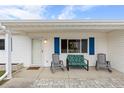 Charming front porch with blue shutters and comfortable rocking chairs at 10662 Se 174Th Loop, Summerfield, FL 34491
