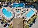 Resort-style pool area with multiple pools, spa, lounge chairs, and ample parking at 11631 Sw 82Nd Ter, Ocala, FL 34481