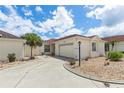 Single-story house with red tile roof and a landscaped yard at 1330 Lajolla Cir, The Villages, FL 32159