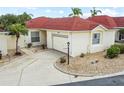 Charming single-story home with a well-manicured lawn, a concrete driveway, and an attached garage at 1330 Lajolla Cir, The Villages, FL 32159