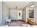 Inviting front porch with brick flooring and white wooden benches at 1463 Cedar Glen Dr, Apopka, FL 32712