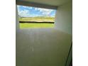 Covered patio with a view of the green backyard and other homes in the neighborhood at 2137 Sunshine Peak Dr, Minneola, FL 34715