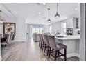 Open kitchen with island, stainless steel appliances, and hardwood floors at 2252 Juniper Berry Dr, Minneola, FL 34715