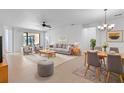 Open concept dining area with wood table, gray chairs, and view of the living room at 233 Monterey St, Kissimmee, FL 34759