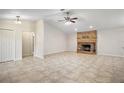 Living room with brick fireplace and tile floors at 25900 Oakridge Ave, Sorrento, FL 32776