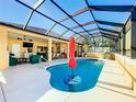 Inviting screened pool area with a covered patio at 305 W Lady Lake Blvd, Lady Lake, FL 32159