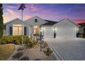 Two-story house with a large driveway and landscaped yard at 3259 Markward Dr, The Villages, FL 32163