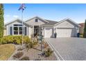 Two-story house with a large driveway and landscaped yard at 3259 Markward Dr, The Villages, FL 32163