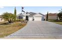 Two-story house with a large driveway and landscaped yard at 3259 Markward Dr, The Villages, FL 32163