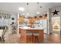 Kitchen with light wood cabinets and an island at 3525 Idlewood Loop, The Villages, FL 32162