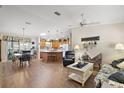 Open living room and kitchen with hardwood floors at 3525 Idlewood Loop, The Villages, FL 32162