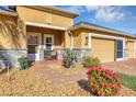 Front entry of house with stone facade and lush landscaping at 4513 Antietam Creek Trl, Leesburg, FL 34748