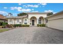 House exterior featuring a covered entryway and brick pavers at 5072 Greens Dr, Lady Lake, FL 32159