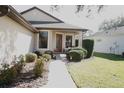 Front entrance with walkway and landscaping at 5622 Sir Churchill Dr, Leesburg, FL 34748