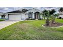 Single story home with attached garage and manicured lawn at 5626 Squires Dr, Leesburg, FL 34748