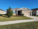 Charming one-story house with a well-manicured lawn and two-car garage at 8065 Penrose Pl, Wildwood, FL 34785