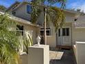 Front entrance of a house with a light-colored exterior and landscaping at 9001 Village Green Blvd, Clermont, FL 34711