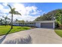 Spacious driveway leading to a newly renovated home at 100 Via Capri, New Smyrna Beach, FL 32169