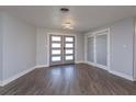 Bright entryway with gray double doors and gray vinyl plank flooring at 100 Via Capri, New Smyrna Beach, FL 32169