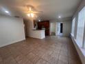 Bright living room with tile floors and access to kitchen and patio at 1075 S Hiawassee Rd # 911, Orlando, FL 32835