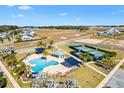 Community pool and tennis courts are seen from above at 1107 Sugar Loaf Key Loop, Lady Lake, FL 32159