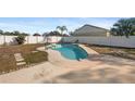 Kidney shaped swimming pool in backyard at 11146 Pine St, Leesburg, FL 34788