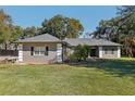 Gray house with a gray roof, white columns, and black shutters at 1209 Elysium Blvd, Mount Dora, FL 32757