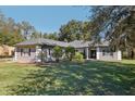 Gray house with a gray roof, white columns, and black shutters at 1209 Elysium Blvd, Mount Dora, FL 32757