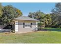 Gray house with a gray roof, white columns, and black shutters at 1209 Elysium Blvd, Mount Dora, FL 32757