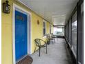 Screened porch with blue door and seating at 1319 Stowe Ave, Mount Dora, FL 32757