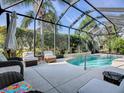 Screened pool area with patio furniture at 1369 Harley Cir, The Villages, FL 32162