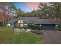 Attractive gray home with landscaped yard, showcasing a modern design at 1701 Cedar Stone Ct, Lake Mary, FL 32746