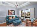 Cozy sitting area with teal sofa and large window at 17889 Gourd Neck Loop, Winter Garden, FL 34787