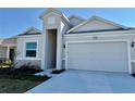Curb appeal! One story home with light gray siding, stone accents and a two-car garage at 2022 Wallingford Loop, Mount Dora, FL 32757