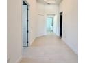 Bright, spacious hallway with light beige tile floors and white walls at 2022 Wallingford Loop, Mount Dora, FL 32757