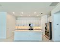 Modern kitchen with a spacious island, stainless steel appliances, and ample cabinet space at 2022 Wallingford Loop, Mount Dora, FL 32757