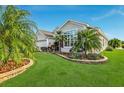 Well-maintained landscaping, inviting entryway, and palm trees at 2054 Vision Ct, The Villages, FL 32163