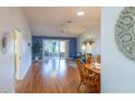 Spacious living room with wood floors and access to patio at 2219 Welcome Way, The Villages, FL 32162