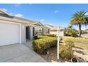 Home's exterior showcasing a well-maintained landscape and driveway at 2304 Jonesbury Run, The Villages, FL 32162