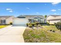 One story house with a landscaped lawn and attached garage at 2304 Jonesbury Run, The Villages, FL 32162