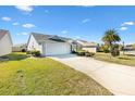 House exterior with a spacious driveway and well-manicured lawn at 2304 Jonesbury Run, The Villages, FL 32162