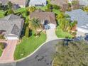 Aerial view of single-Gathering home with landscaped yard and driveway at 2338 Mcclellanville Ter, The Villages, FL 32162