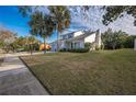 House exterior showcasing a two-story home with palm trees and a yard at 2355 Lakeview Ave, Clermont, FL 34711