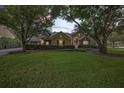 Stunning home with mature trees and a manicured lawn at 25833 Feather Ridge Ln, Sorrento, FL 32776