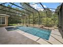 Relaxing screened pool and spa with surrounding patio at 25833 Feather Ridge Ln, Sorrento, FL 32776